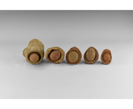 Group of five wind-rounded pebbles with their individual hollowed out 'nests', from the Kalahari Desert region, western Afric