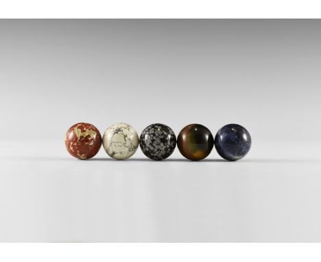 A group consisting of five gemstone spheres, including one each of: tiger iron, brecciated jasper, howlite, sodalite, and sno