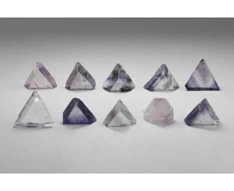Group of ten of clear to purple and lavender triangular cleaved fluorite crystals, some with strong colour-banding, from the 