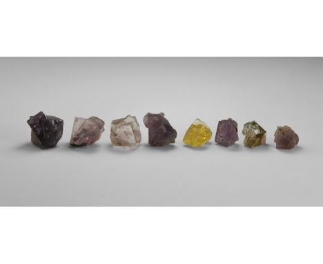 A group of eight cubic fluorite crystals in mixed colours, in old white card tray. From the historic ‘Victorian Museum’ colle