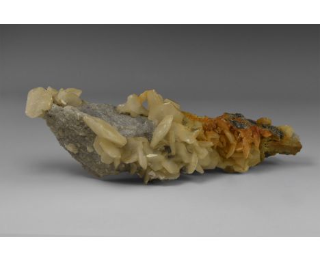 An unusual calcite occurrence with numerous nailhead calcite crystals encrusting a finger-like shaft of limestone, in old whi