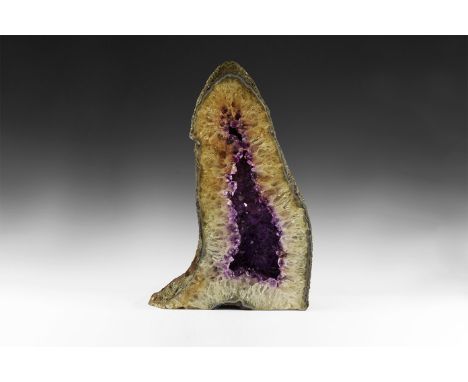 A fine amethyst 'cathedral' agate lined geode, with richly coloured amethyst crystals layered over rock crystal and citrine c