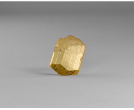 A gem-quality yellow scapolite crystal with unusually fine crystallisation, from Handeni, Tanzania; in old white card tray. F