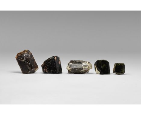 A group of five dravite (brown) tourmaline crystals from Australia, all terminated, one with adhering quartz and muscovite, i