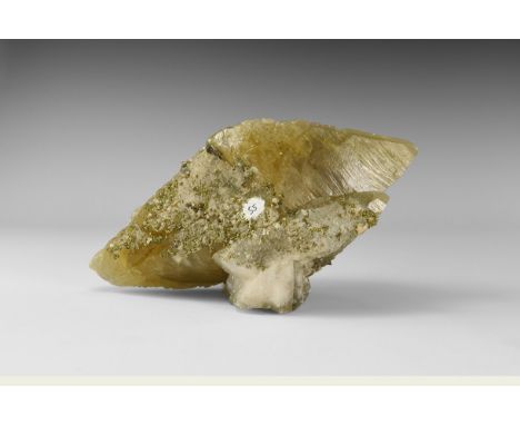 A large, unusual double-terminated scalenohedron of calcite, with additional smaller scalenohedrons adhering, and with numero
