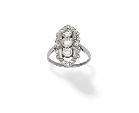 DIAMOND PLAQUE RING, CIRCA 1935Set with three old brilliant-cut diamonds within an openwork surround set with baguette and si