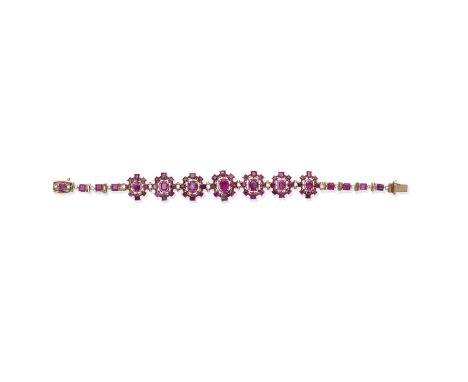 RUBY, PINK SAPPHIRE AND DIAMOND BRACELETSet with seven, oval and step-cut, ruby and pink sapphire clusters, between similarly