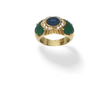 CARTIER: GEM-SET AND DIAMOND RING,  1990The oval sapphire cabochon within a brilliant-cut diamond surround, between carved ch