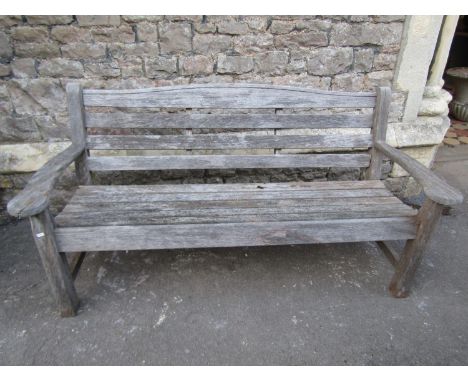 A Swan Hattersley weathered teak three seat garden bench with slatted seat and back beneath a curved rail, 163 cm long (af) 