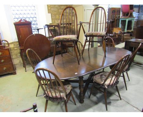 An Ercol extending dining table, 71cm high, 210 x 108cm (maximum) together with eight Errol dining chairs including two carve