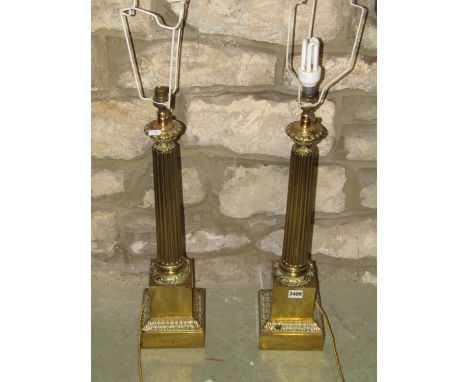 A large pair of brass table / desk lamps, presented as fluted columns on stepped plinth bases, 60cm high 