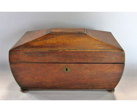 A 19th century mahogany sarcophagus tea caddy with two caddys and a mixing bowl, 34cm wide (missing 1 handle) 