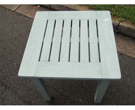 Weathered painted teak garden bench, 125 cm wide, together with an associated side table, 53 cm high, 55 x 55 cm, both painte