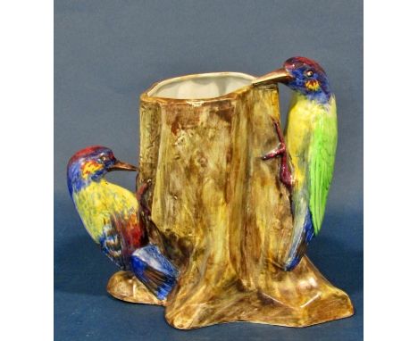 Three Radford pottery vases decorated with five woodpeckers together with a further model bird, a wall pocket decorated with 