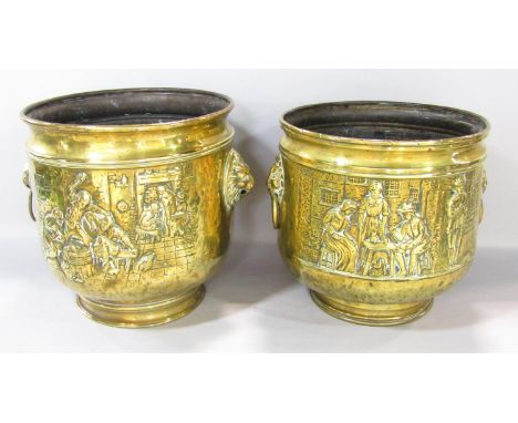 A pair of brass coal buckets with embossed tavern scenes and lion mask handles (one lacks ring) 26cm diameter 