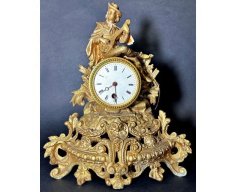 A 19th century Spelter figurative mantel clock with a golden finish, 33cm high. 