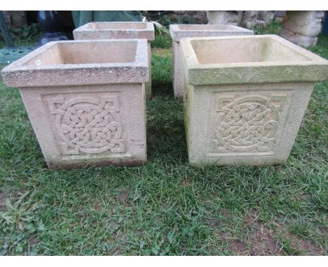 A run of four weathered cast composition stone planters of square cut form with Celtic knot panels 32 cm square x 30 cm high 