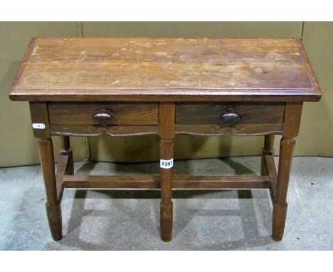 A small continental oak two drawer side / occasional table, with carved apron, raised on tapering turned legs, 42cm high, 62 