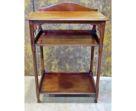 An Edwardian mahogany three tier side table with reeded column supports, 61 cm wide 