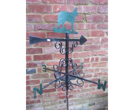 A partially painted weather vane, topped with finial in the form of a dog, 78cm high 