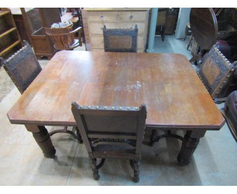 An Edwardian oak dining table, with canted corners raised on broad fluted supports and casters, 73 cm high, 155 x 160 cm, tog