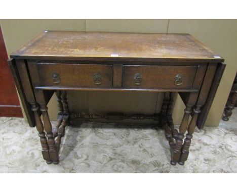 An unusual country oak gate leg sofa / occasional table, with two drawers, raised on turned supports, 76cm high, 177 x 50cm 