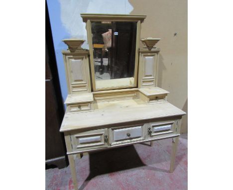 An Edwardian stripped and waxed pine dressing table with central mirror and square taper legs.110cm wide 