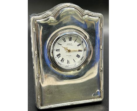 A sterling silver miniature mantel clock, Sheffield 1998, maker Carrs of Sheffield Ltd, a silver serving spoon in crazing des