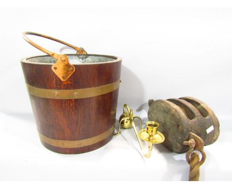 A reproduction brass bound oak peat/ coal bucket with zinc liner, a ship's pulley and an Arts &amp; Crafts brass candlestick,