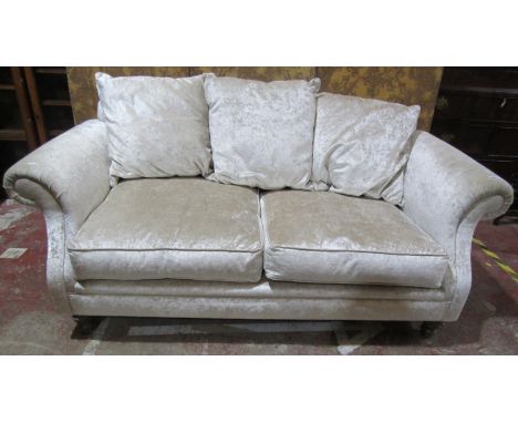 A traditional two seat sofa with scrolled arms and additional loose cushions.190cm wide 