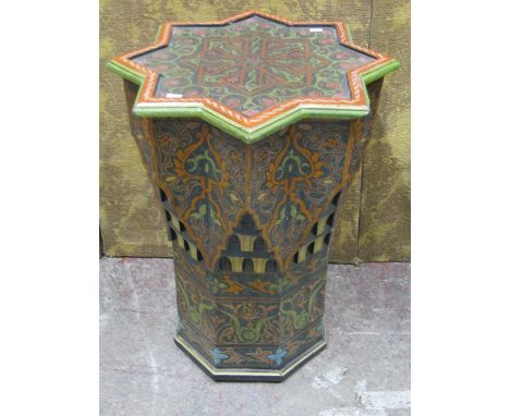 A decorative carved and painted Moroccan / Marrakesh lamp table, the top of star form, with inset glass, 71cm high, 57cm diam