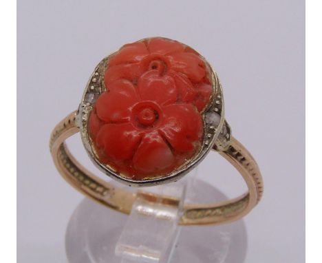 Yellow metal coral ring carved with flowers and further set with rose-cut diamonds, size R, 3.2g 