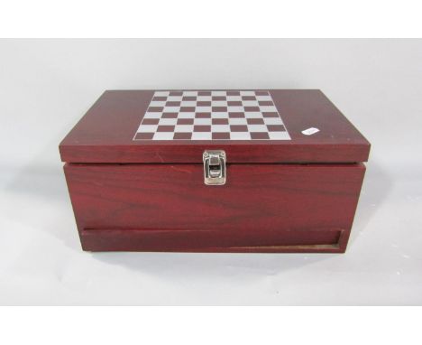 A presentation chess board containing two bottles of wine, a chess set and a swing drawer with a cork screw, wine thermometer