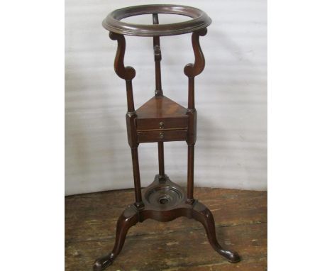 Georgian mahogany wash stand, the circular ringed top supported on a tricorn frame, with two small frieze drawers and a tripo