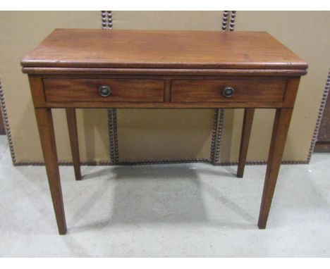 A George III two drawer folding tea table, 75cm high, the top measuring 90 x 90cm (maximum) 