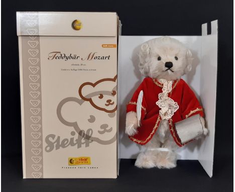 'Mozart' teddy bear by Steiff, secured as new in original box, wearing red velvet jacket and with built-in musical box. Limit