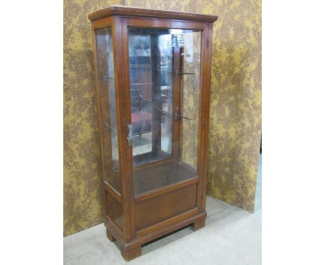 An early 20th century freestanding display cabinet with mirror panelled back enclosed by a full length partially glazed panel