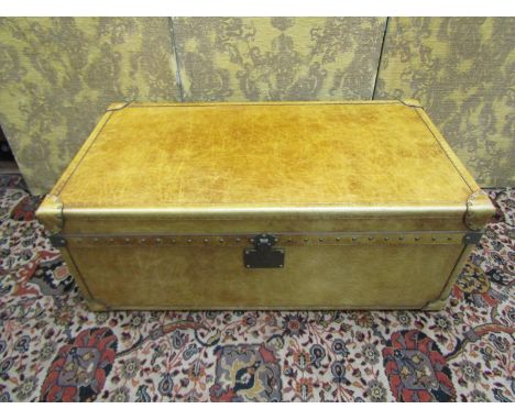 A good quality travelling trunk ottoman with pale tan coloured leather finish and studwork borders, 109 cm length 