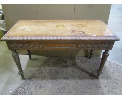 A stripped pine side / console table, the bevelled top with carved egg &amp; dart border over a further carved frieze and tap