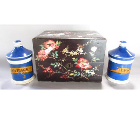 A Chinese black lacquered tea caddy, with floral and bird Mother of pearl decoration, containing two famille verte porcelain 