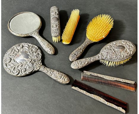 A silver brush and comb set with Green Man mask detail including a pair of mirrors, pair of hair brushes, and a pair of cloth