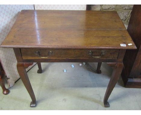 A George III country oak side table, with single frieze drawer, raised on bladed cabriole supports, 73cm high, 83 x 54cm 