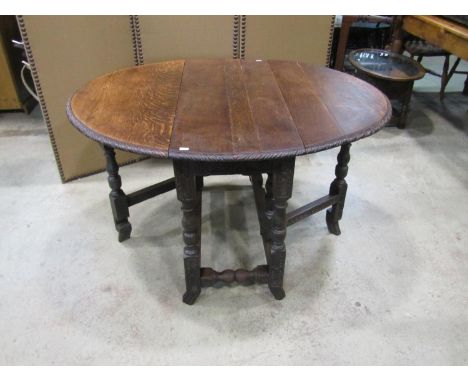 A small 19th century carved country oak gateleg table, raised on swept carved supports, 72cm high, 96 x 124cm (maximum) 