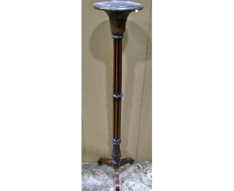 A tall carved mahogany tripod torchere, 166cm high 