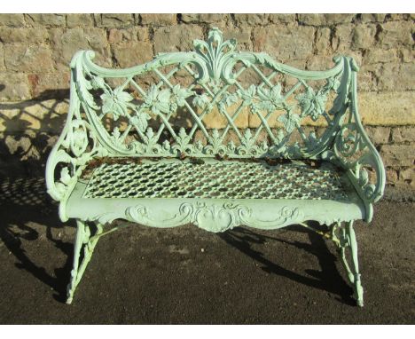 A good weathered light green painted  cast alloy two seat garden bench with scrolling Rococo style frame, pierced lattice sea