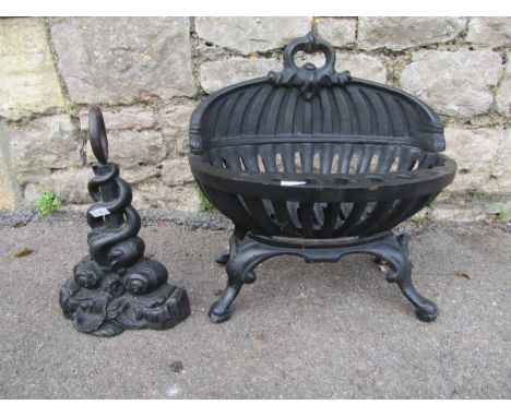 A small painted cast-iron fire basket, 40 cm high, 38 cm wide together with a cast iron doorstop in the form of symmetrical c