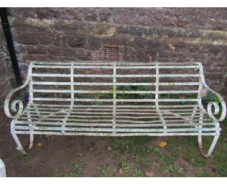 A good painted and weathered 19th century iron strapwork garden bench with simple open scrolled arms and sprung steel support