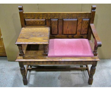 A 20th century oak telephone bench / table, loosely in the old English style, 93cm high, with applied badge ‘Adam Bede’ 