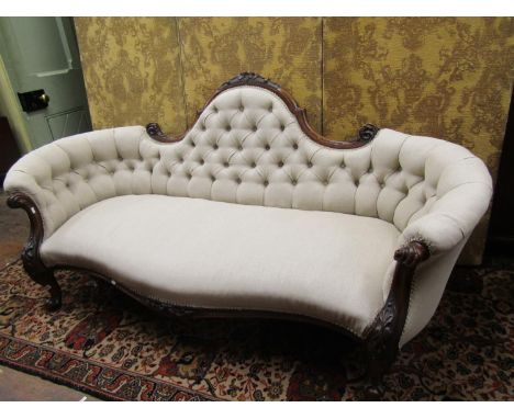 Victorian drawing room sofa with serpentine outline, the swept back with carved and moulded show wood detail, raised on cabri