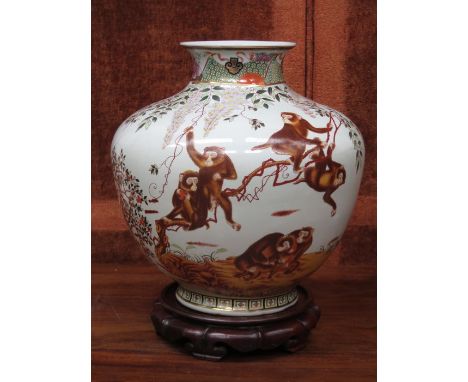 LARGE ORIENTAL STYLE GLAZED CERAMIC VASE DECORATED WITH MONKEYS ON WOODEN STAND, STAMPED UW1899, APPROXIMATELY 36cm HIGH